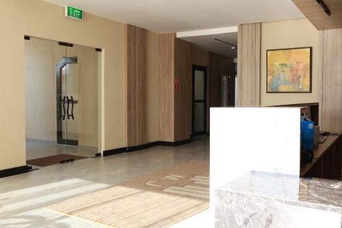 a hallway with a glass door in a building at BHomed Shaab in Kuwait