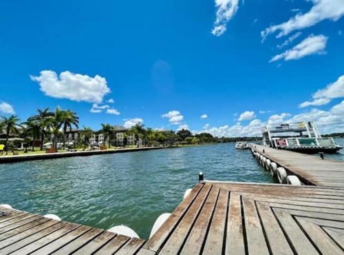 a river with a wooden pier with a boat on it at View 462 Só para você! in Brasilia