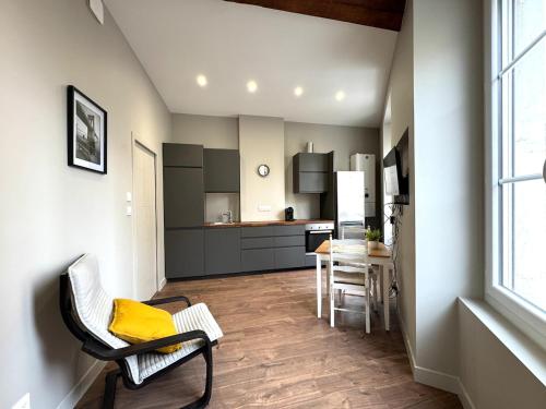 a kitchen with a table and chairs in a room at Appartement agréable proche gare in Vienne