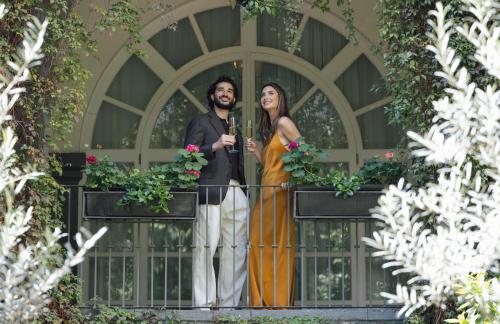 a man and a woman standing on a fence at Four Seasons Hotel Mexico City in Mexico City