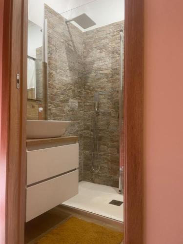 a bathroom with a sink and a shower at airport room -1 in Azzano San Paolo