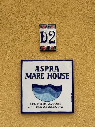 a sign for a marmitemite mare house on a wall at Aspra Mare House in Aspra