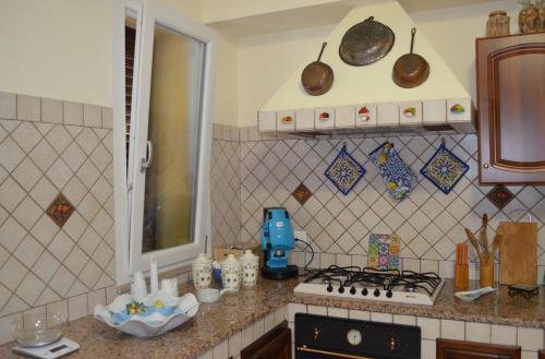 a kitchen with a stove and a counter top at Aspra Mare House in Aspra