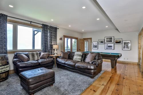 a living room with leather couches and a pool table at Southern Views in Jasper