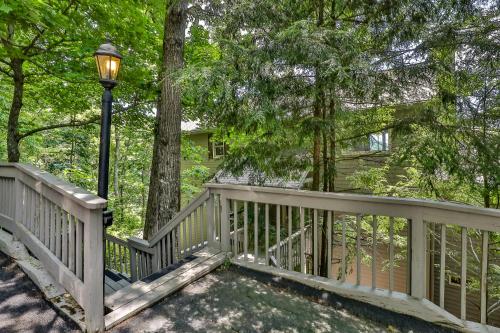 a wooden deck with a light pole and trees at Southern Views in Jasper