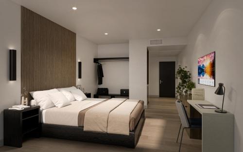 a bedroom with a large bed and a desk at Kins Hotel in Los Angeles