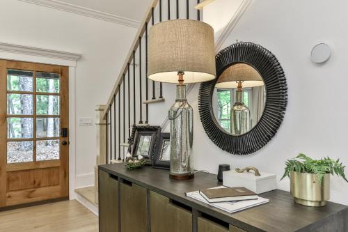 a room with a table with a lamp and a mirror at Robins Nest at Big Canoe - Big Canoe, GA - Enjoy Peaceful Forest Views, Rack Up a Game of Pool, and Enjoy Game Nights in the Gam in Jasper