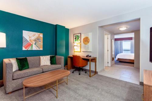 a living room with a couch and a table at Holiday Inn Hotel & Suites Daytona Beach On The Ocean by IHG in Daytona Beach