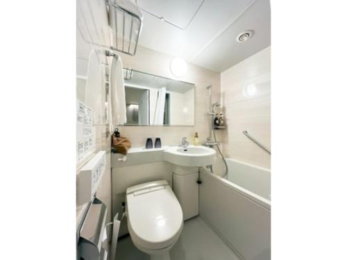 a bathroom with a toilet and a sink and a tub at Garden Hotel Shizuoka - Vacation STAY 45845v in Shizuoka