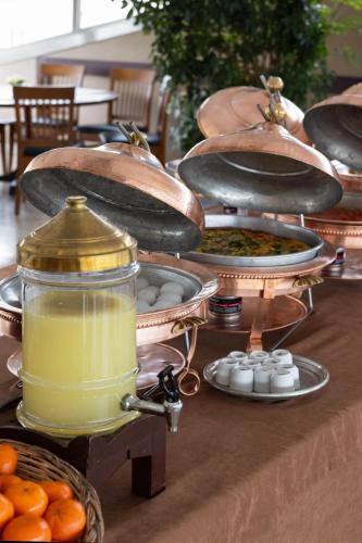 a table with plates of food and a jar of liquid at Armada Istanbul Old City Hotel in Istanbul