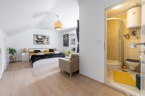 a bedroom with a bed and a bathroom at Apartment Ira in Dubrovnik