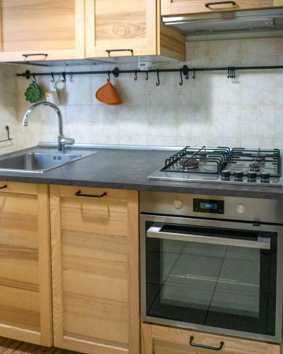 a kitchen with a stove and a sink at Casa Elena in Castiglione in Teverina