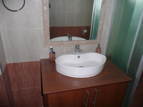 a bathroom with a sink and a mirror at Labetia Apartments in Áyioi Apóstoloi