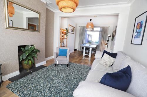 a living room with a couch and a chair at Lisburn Townhouse in Lisburn