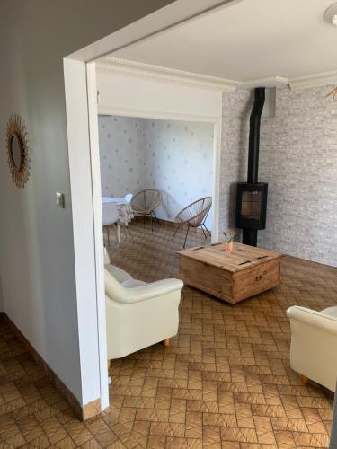 a living room with a couch and a table at GITE du Petit Maine in Pontmain