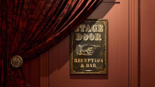 a sign hanging on a wall next to a curtain at Hotel Indigo Edinburgh by IHG in Edinburgh