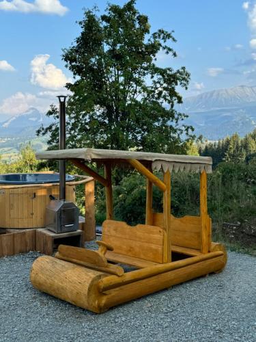 a wooden bench with a stove with a view of mountains at Mała Bawaria in Zakopane