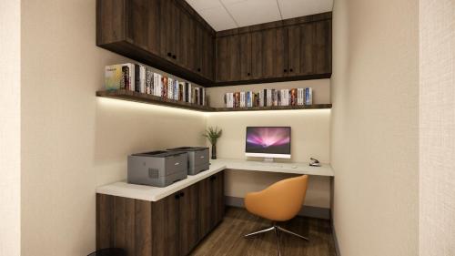 a room with a desk with a computer and a chair at Kins Hotel in Los Angeles