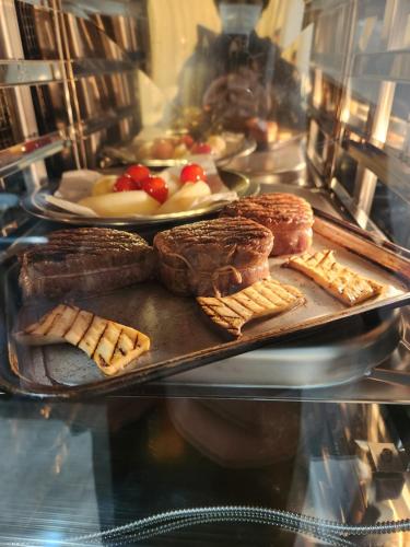 a tray of pastries and breads on a display at Pension Green Lake in Gujo