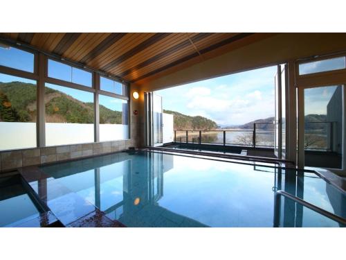 a house with a swimming pool with a view at Ashiwada Hotel - Vacation STAY 60808v in Oishi