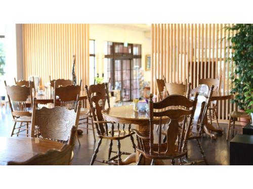 a dining room with wooden tables and chairs at Ashiwada Hotel - Vacation STAY 60808v in Oishi