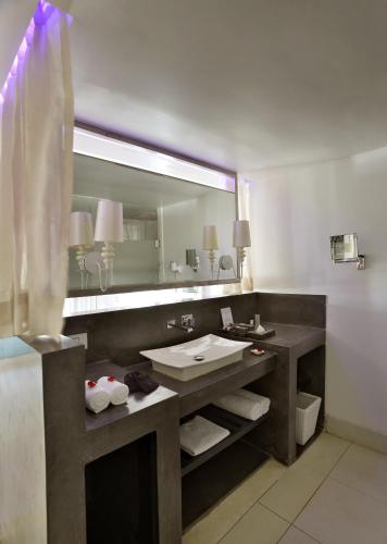 a bathroom with a sink and a large mirror at The Park Calangute Goa in Calangute