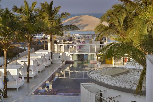 a view of a resort with white chairs and palm trees at The Park Calangute Goa in Calangute
