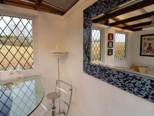 a bathroom with a mirror and a window at The Corner House in Woodbridge