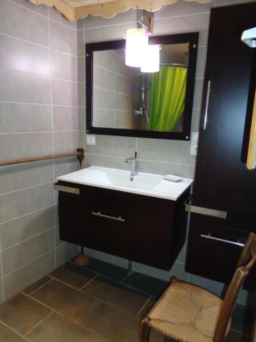 une salle de bain avec un lavabo et un miroir dans l'établissement Appartement de plain pied dans chalet, à Saint-Sorlin-dʼArves