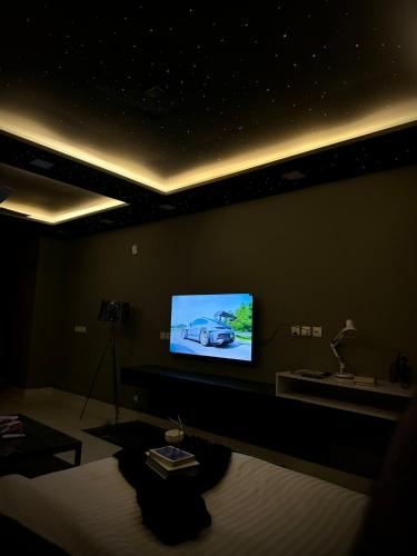 a living room with a flat screen tv on a wall at Starlit By Zameen Opal in Lahore