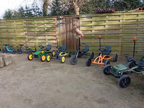 a group of tricycles parked next to a fence at DE SMISHOEVE met kinderpret, dieren en wellness in Heers