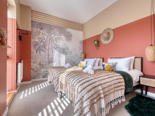 a bedroom with two beds and orange walls at Cambridge - hot tub, sauna, parking, pool table in Trumpington
