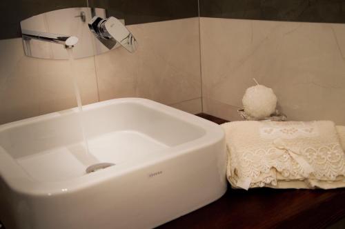 a bathroom with a white sink and a towel at Il Centenario in Ascea