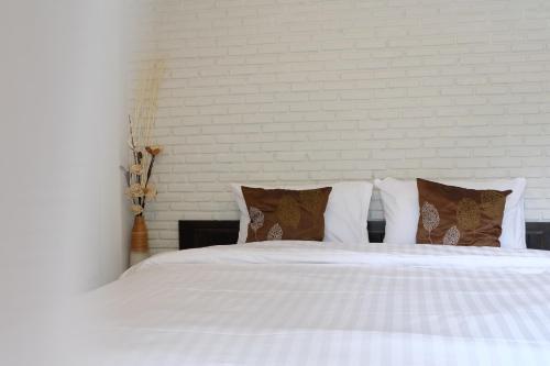 Ένα ή περισσότερα κρεβάτια σε δωμάτιο στο Kittawan Home&Gallery