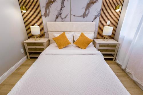 a bedroom with a white bed with two night stands at Exotic home Cumberland street by sdstay in San Diego