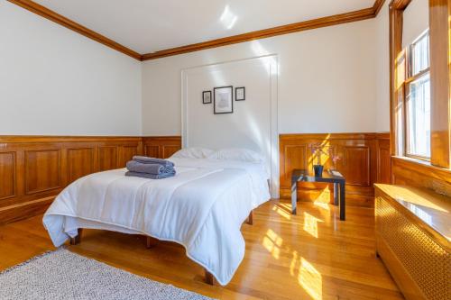 a bedroom with a bed and a table and a window at Private Cozy Room #C in Boston