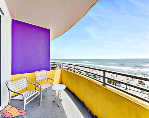 a balcony with two chairs and a table and the ocean at Highly Desired 6th Floor 1 BR Oceanfront - There Is Only One Ocean Walk Resort 606 in Daytona Beach