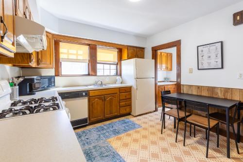 a kitchen with a table and a white refrigerator at Private Cozy Room #C in Boston