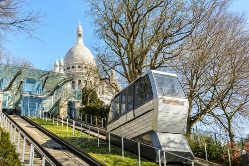 a bus on a fence in front of a building at Studio au cœur de Montmartre in Paris