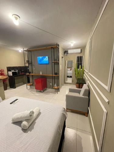 a hotel room with a bed and a tv at Jr flats in João Pessoa