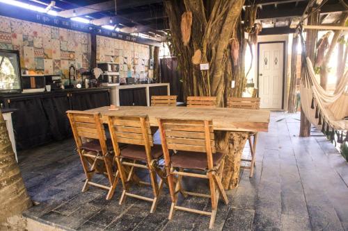 a large wooden table in a room with chairs at El Refugio de Sayulita - Solo Adultos in Sayulita