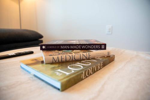 three books stacked on top of each other on a table at Sandbar Serenade in South Padre Island