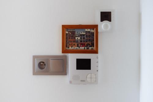 a wall with a microwave and a picture on it at Studio cosy 28 mn aéroport CDG 34 mn chatelet in Livry-Gargan