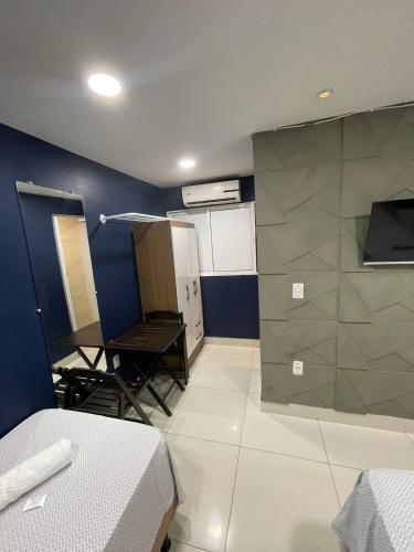 a room with a room with a bed and a kitchen at Jr flats in João Pessoa