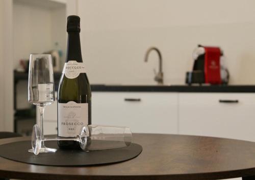 a bottle of wine and a glass on a table at Dal Maestro Bed&Comfort in Gioia del Colle