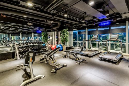 a gym with cardio equipment and treadmills at Chic City Apartment with parking Canal View RoofDeck in Indianapolis