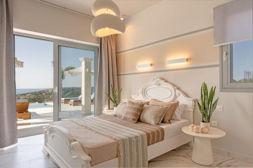a bedroom with a white bed and a large window at Natural Stone Villas Kefalonia in Trapezaki