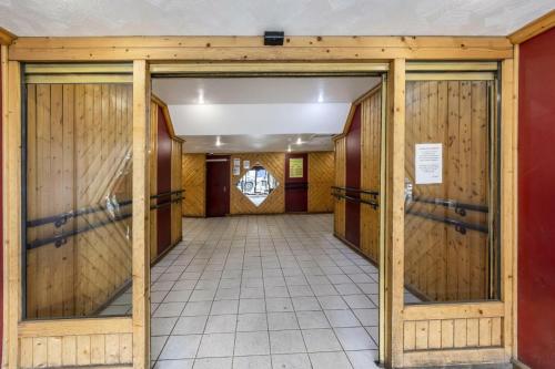a hallway with wooden doors in a building at Résidence Neves - VAL THORENS location: Studio ensoleillé pour 4 personnes dans un quartier animé (LES NEVES) MAE-9081 in Val Thorens