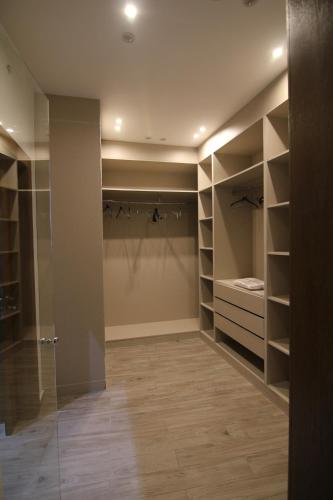 a walk in closet with shelves and a glass door at 3 Appartements Vue sur Mer dans une maison indépendante in Tangier