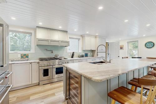 a kitchen with white cabinets and a large kitchen island at Golden Hour Hideaway in Hancock